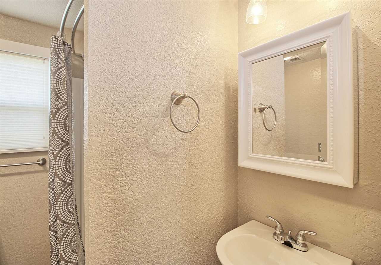 1302-17 17 1/2 Road Fruita, CO 81521 - Photo 23 of 39 a bathroom with a granite countertop shower a sink and a mirror