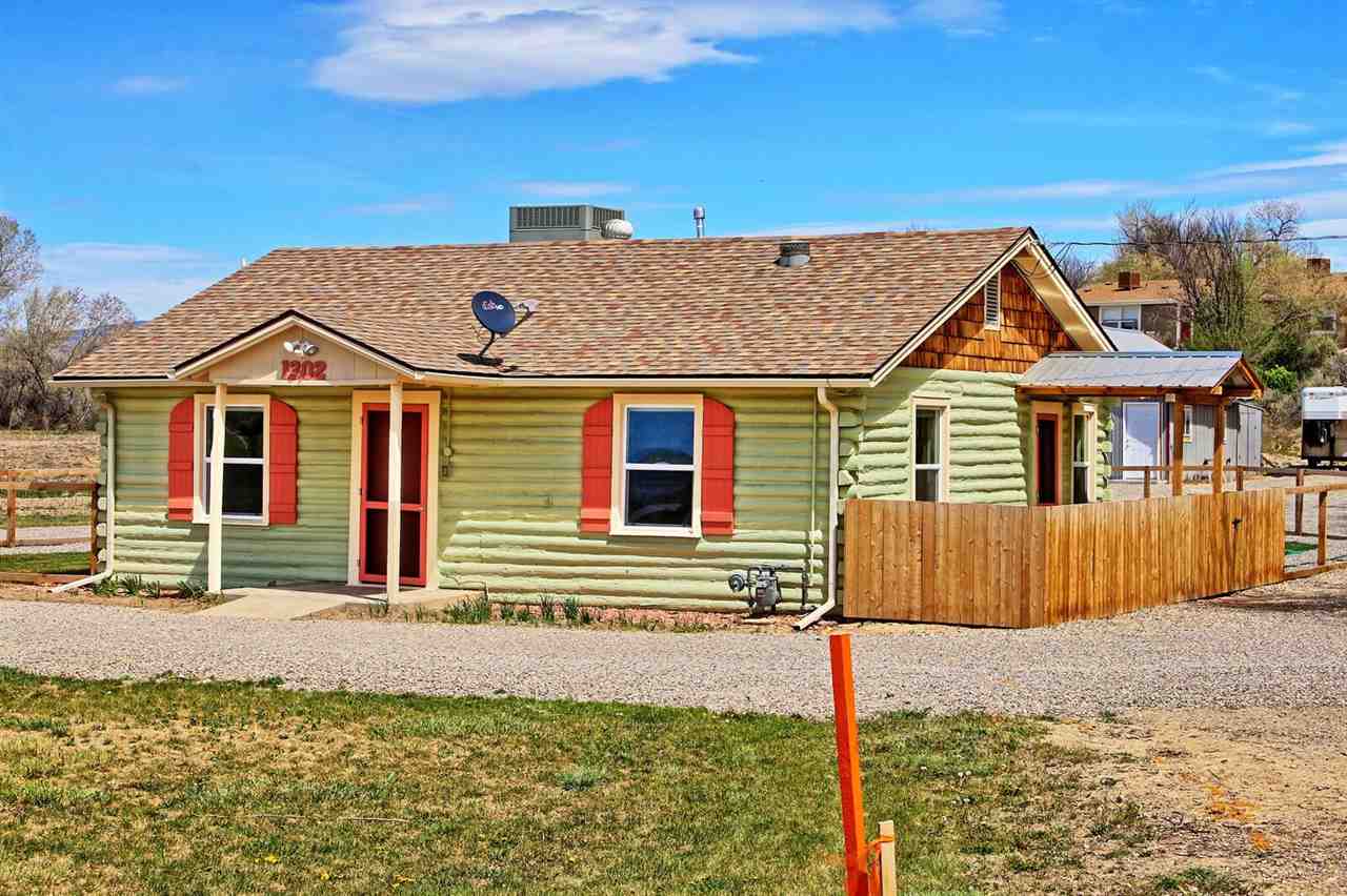 1302-17 17 1/2 Road Fruita, CO 81521 - Photo 3 of 39 a front view of a house with a garden