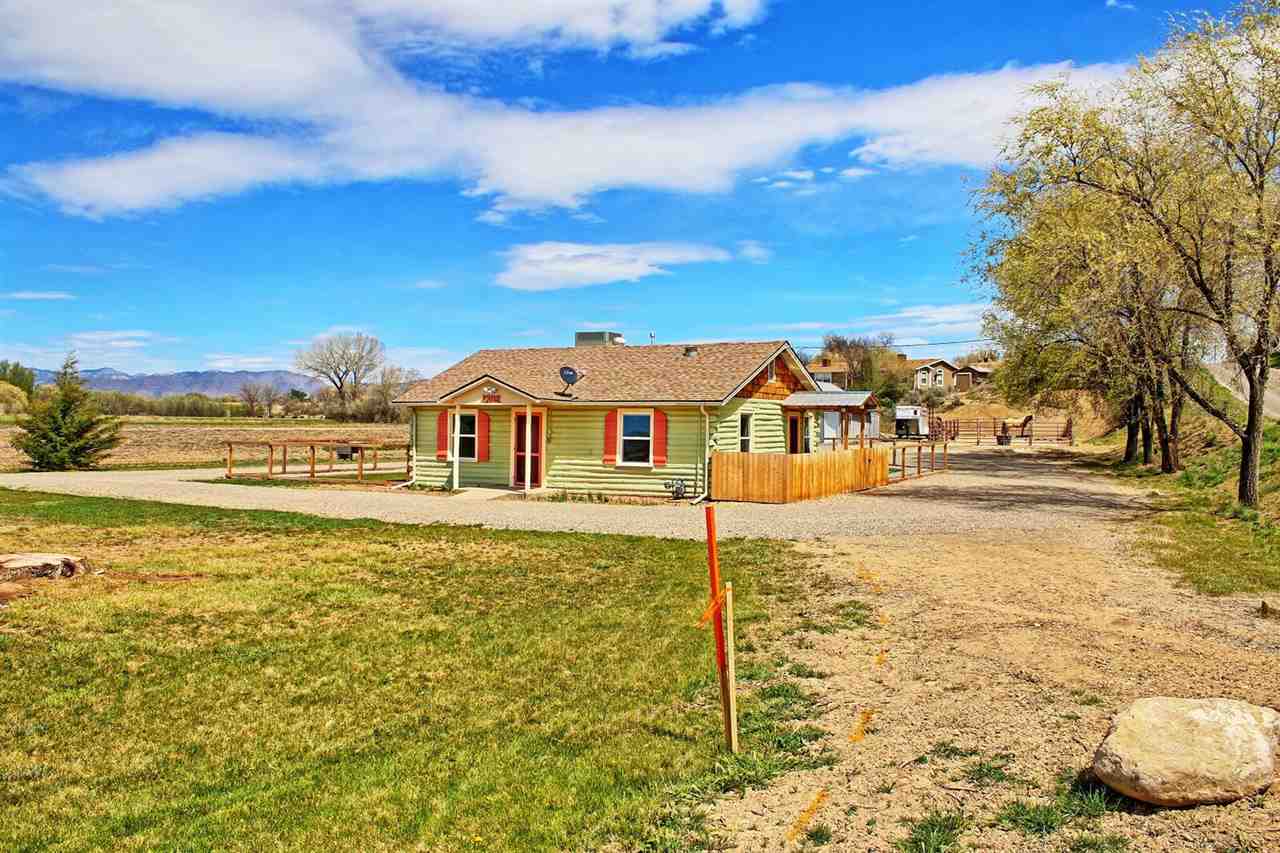 1302-17 17 1/2 Road Fruita, CO 81521 - Photo 6 of 39 a front view of a house with a yard