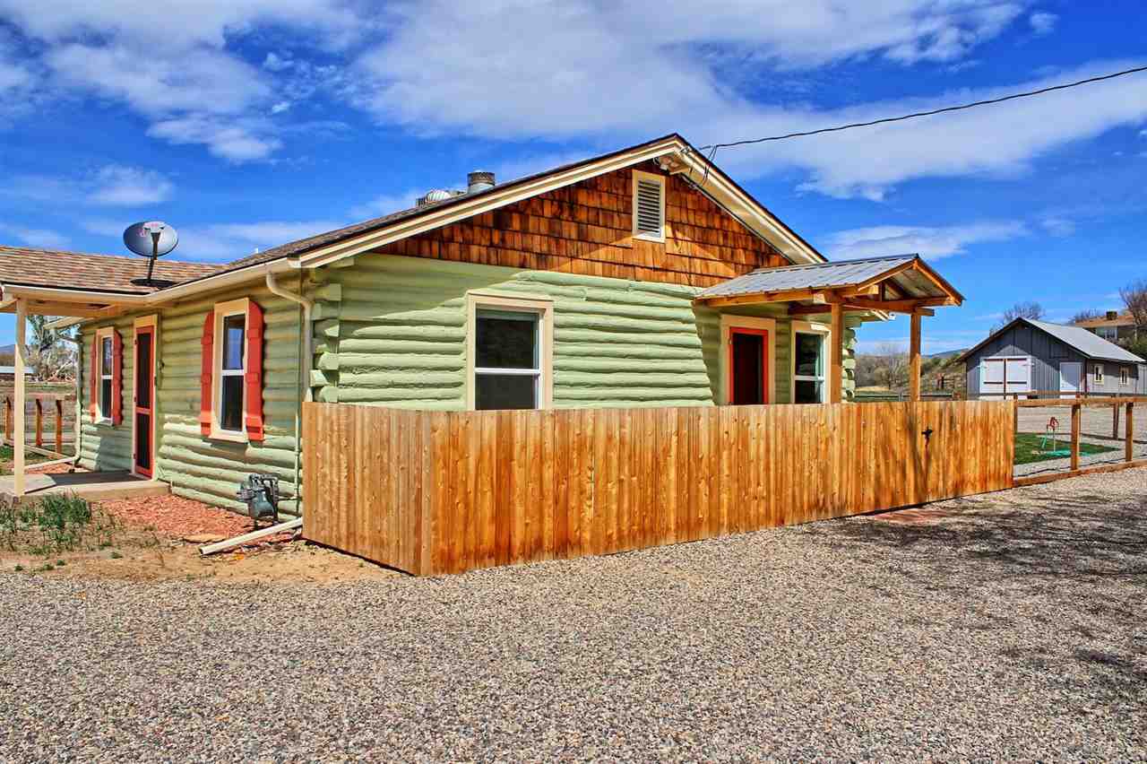 1302-17 17 1/2 Road Fruita, CO 81521 - Photo 7 of 39 a front view of a house with a yard
