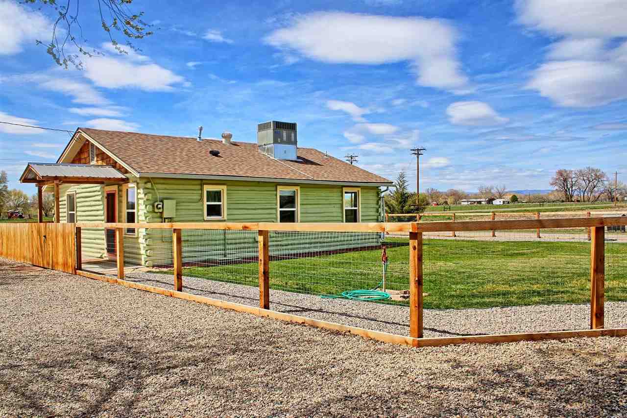 1302-17 17 1/2 Road Fruita, CO 81521 - Photo 8 of 39 a front view of a house with a yard