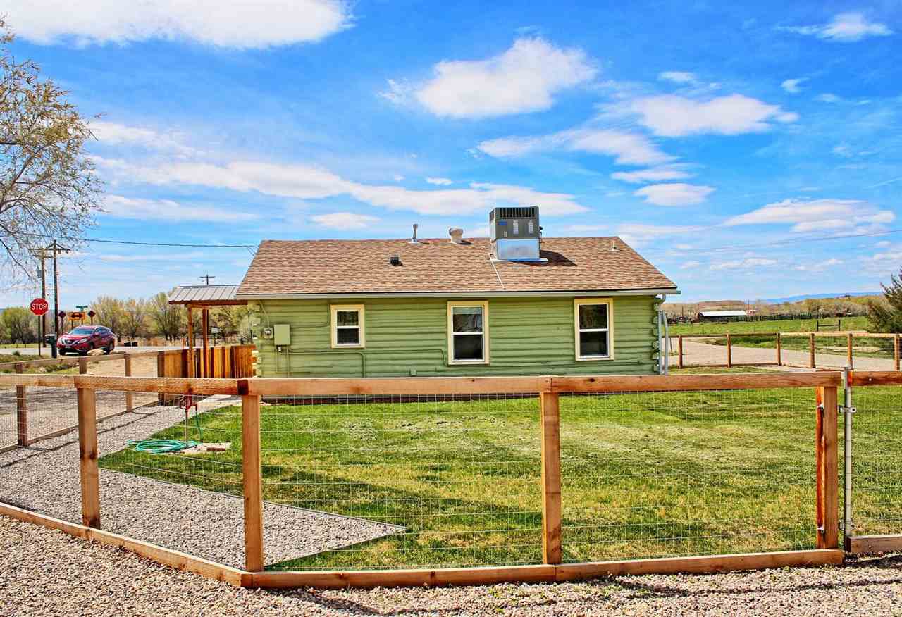 1302-17 17 1/2 Road Fruita, CO 81521 - Photo 9 of 39 a front view of a house with a yard