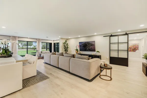 a living room with furniture a mirror and a lamp