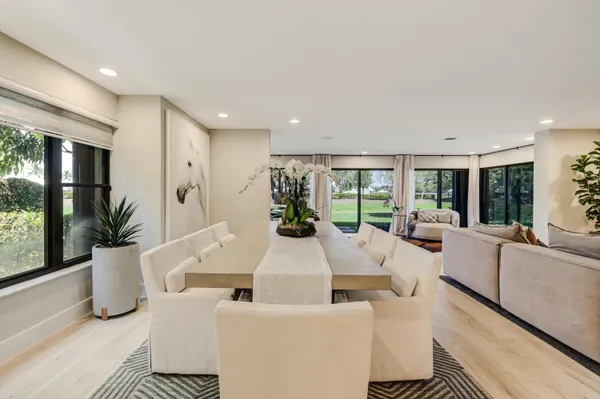 a kitchen with stainless steel appliances kitchen island granite countertop a sink and white cabinets