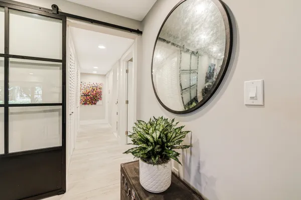 a bathroom with a shower a sink mirror and toilet