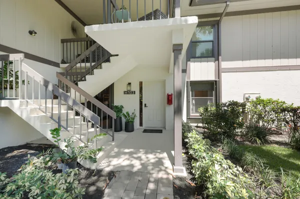 a kitchen with stainless steel appliances kitchen island granite countertop a stove a sink and a refrigerator