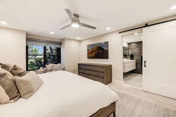 a bedroom with a bed and a wall painting