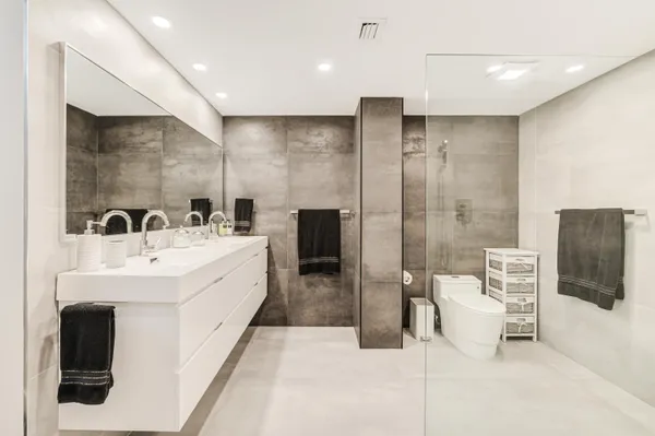 a utility room with stainless steel appliances granite countertop a sink and a stove