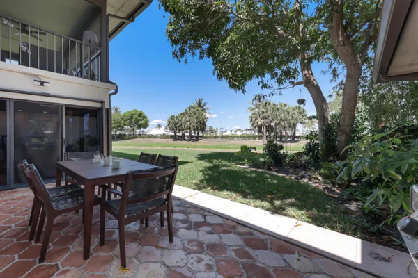 a view of a house with a yard and sitting area