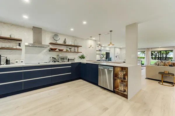 a kitchen with stainless steel appliances a refrigerator and wooden cabinets