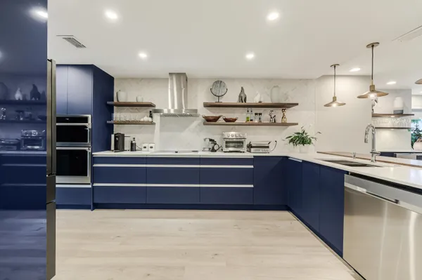 a kitchen with stainless steel appliances kitchen island granite countertop a sink and cabinets