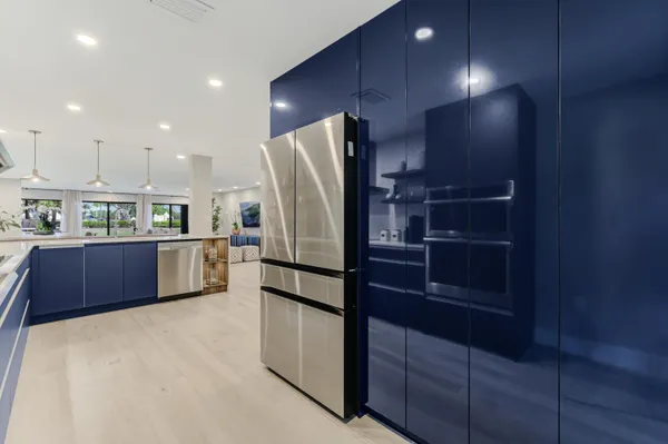 a kitchen with stainless steel appliances kitchen island a large counter space and cabinets