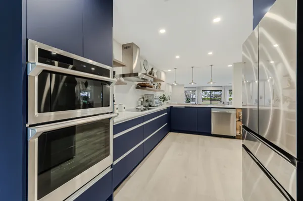 a kitchen with stainless steel appliances kitchen island granite countertop a sink and cabinets