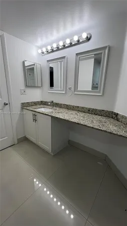 a bathroom with double sink and a mirror