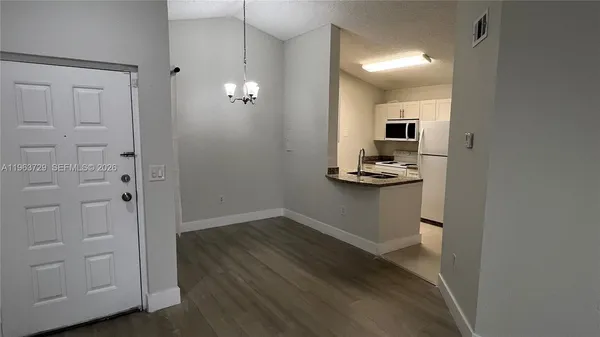 wooden floor in an empty room with a mirror
