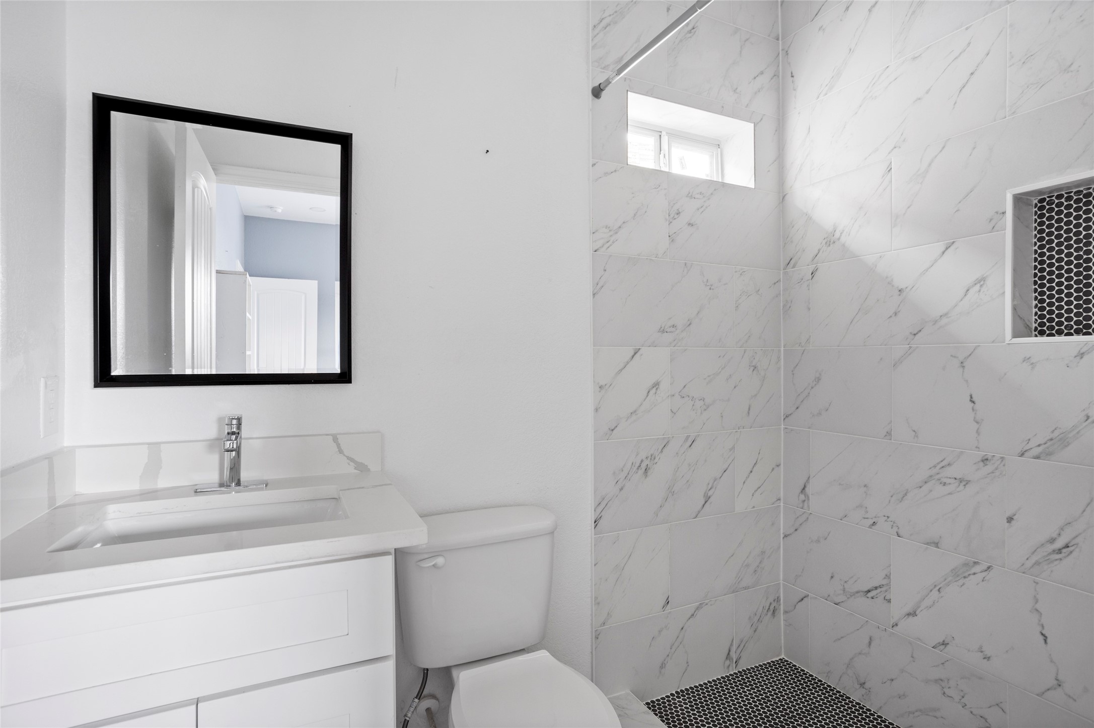 9814 Masterson Street Houston, TX 77029 - Photo 13 of 21 a bathroom with a toilet sink vanity and mirror