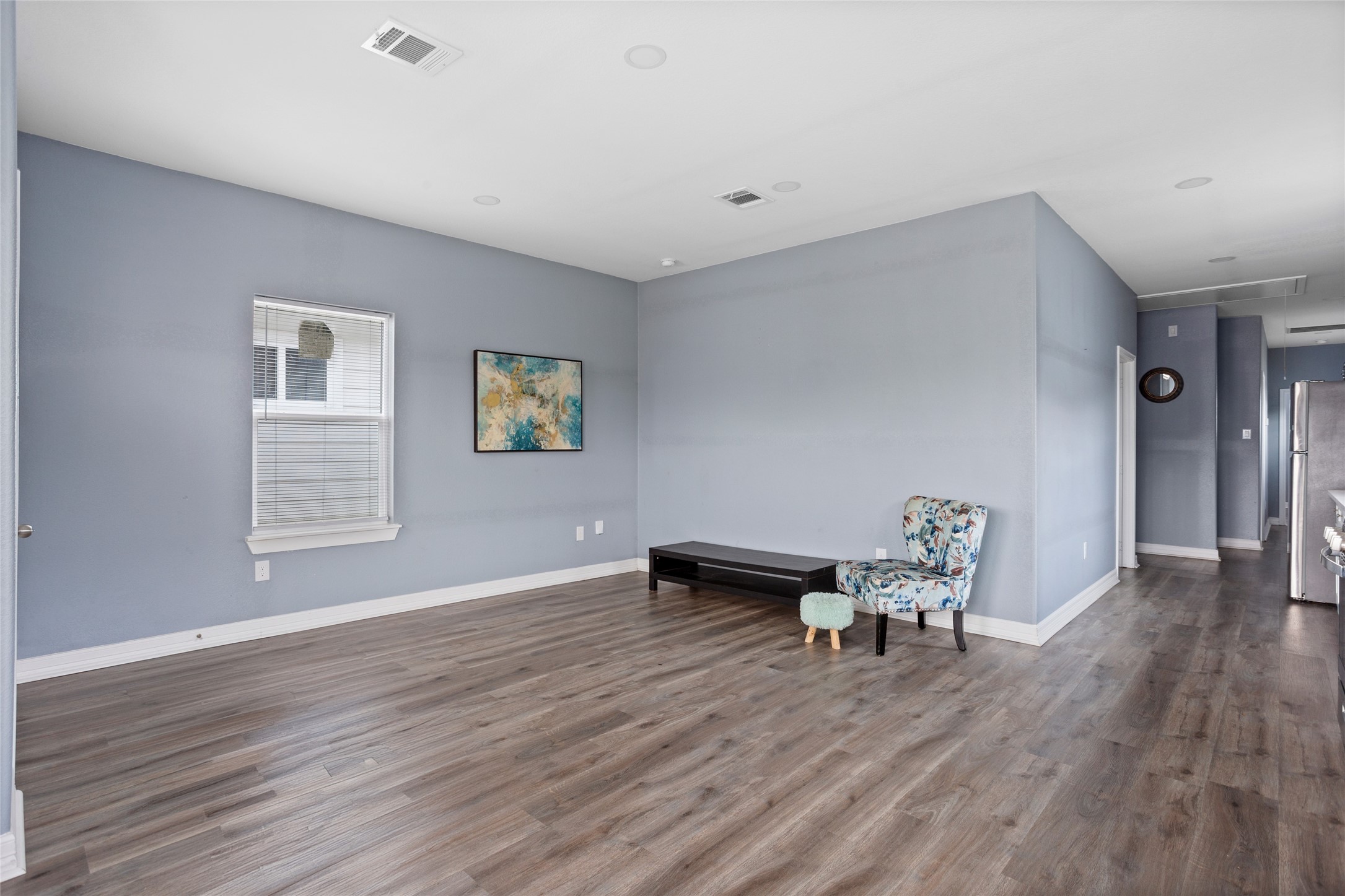 9814 Masterson Street Houston, TX 77029 - Photo 5 of 21 a view of an empty room with wooden floor and a window