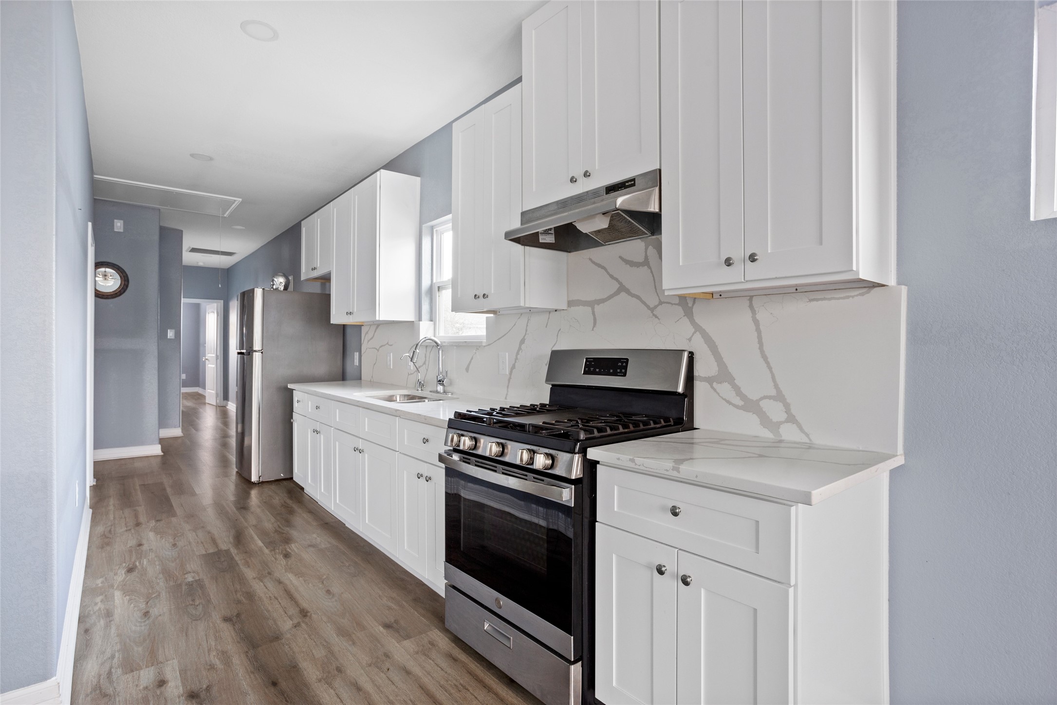9814 Masterson Street Houston, TX 77029 - Photo 8 of 21 a kitchen with white cabinets and appliances