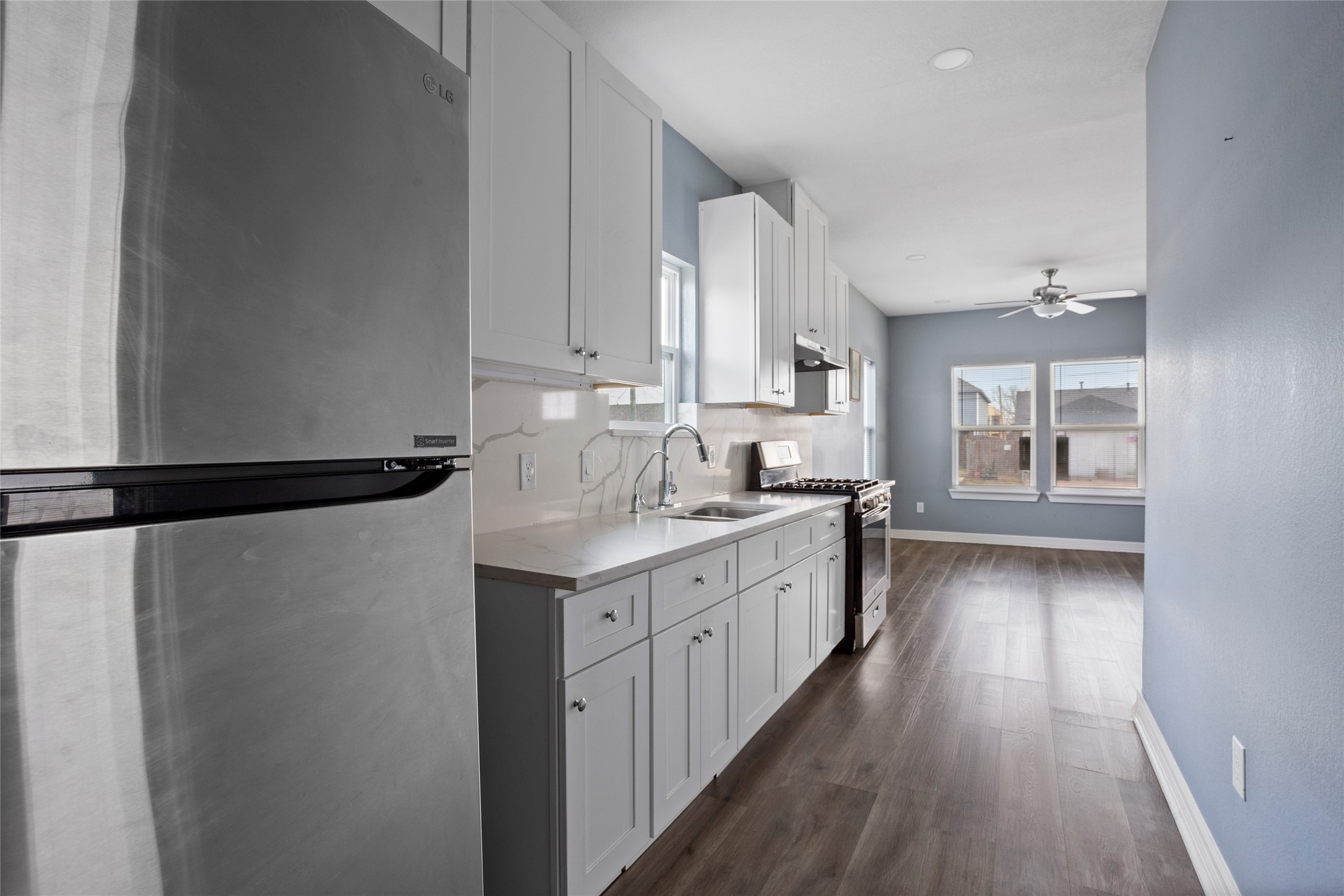 9814 Masterson Street Houston, TX 77029 - Photo 9 of 21 a kitchen with granite countertop a sink a counter space and cabinets
