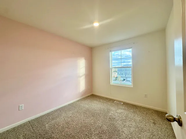 an empty room with a empty space and windows