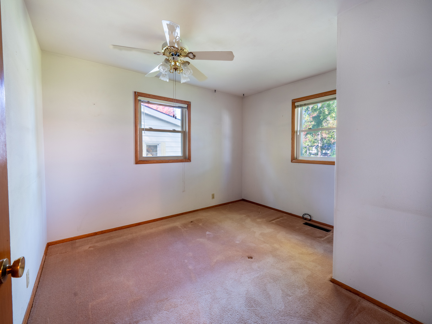 615 Best Avenue DeKalb, IL 60115 - Photo 12 of 12 an empty room with a chandelier fan and windows