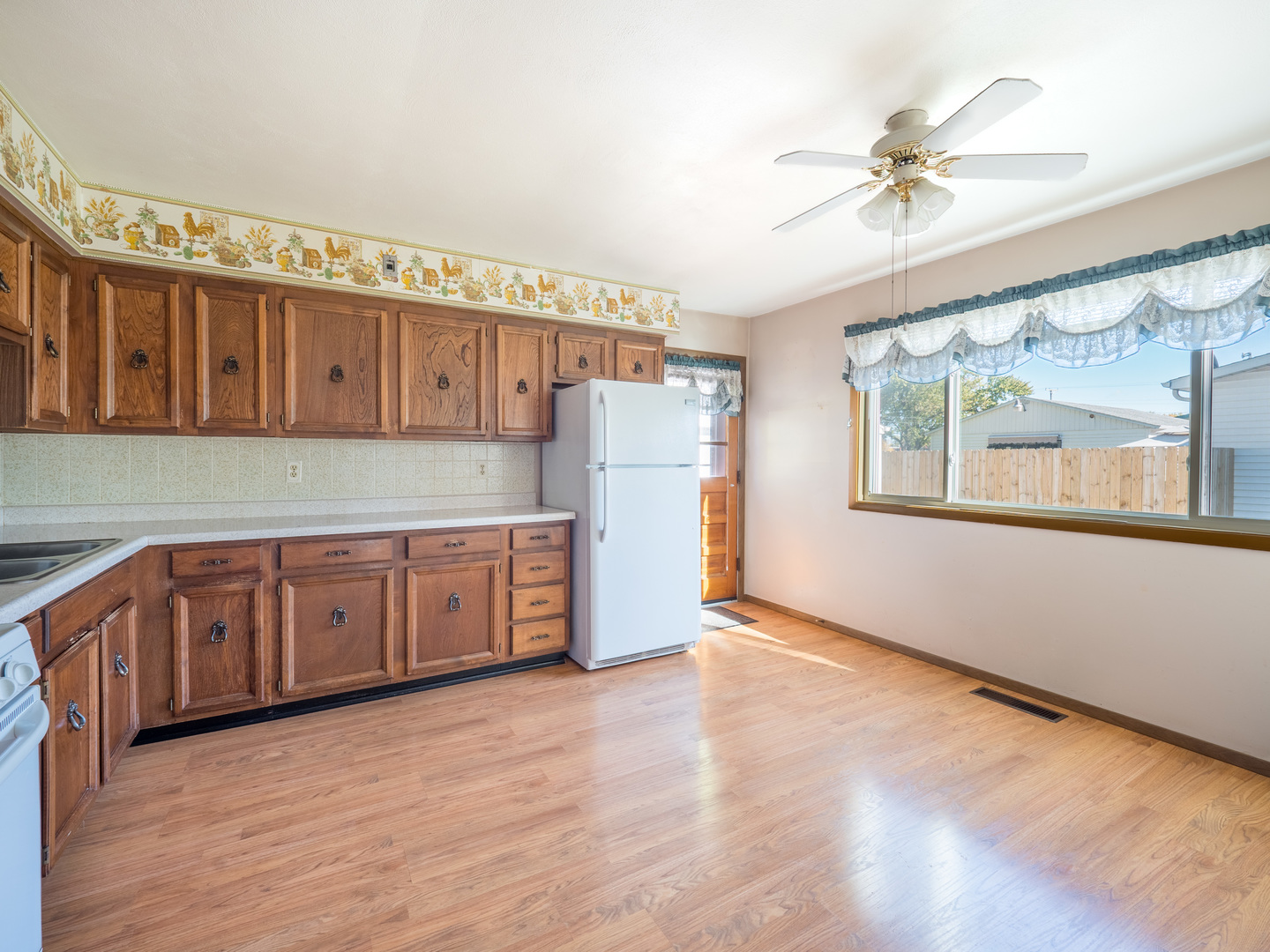615 Best Avenue DeKalb, IL 60115 - Photo 8 of 12 a view of a kitchen with wooden cabinet and a hallway
