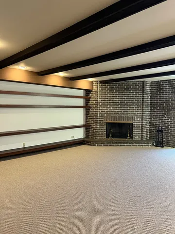 a view of empty room with a fireplace