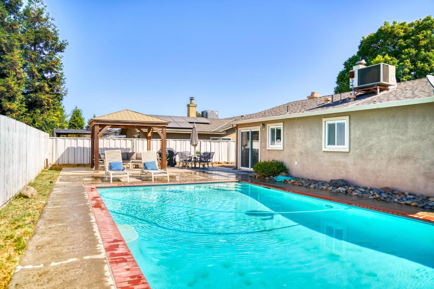 731 Dixie Lane Ripon, CA 95366 - Photo 16 of 22 a front view of a house with swimming pool having outdoor seating