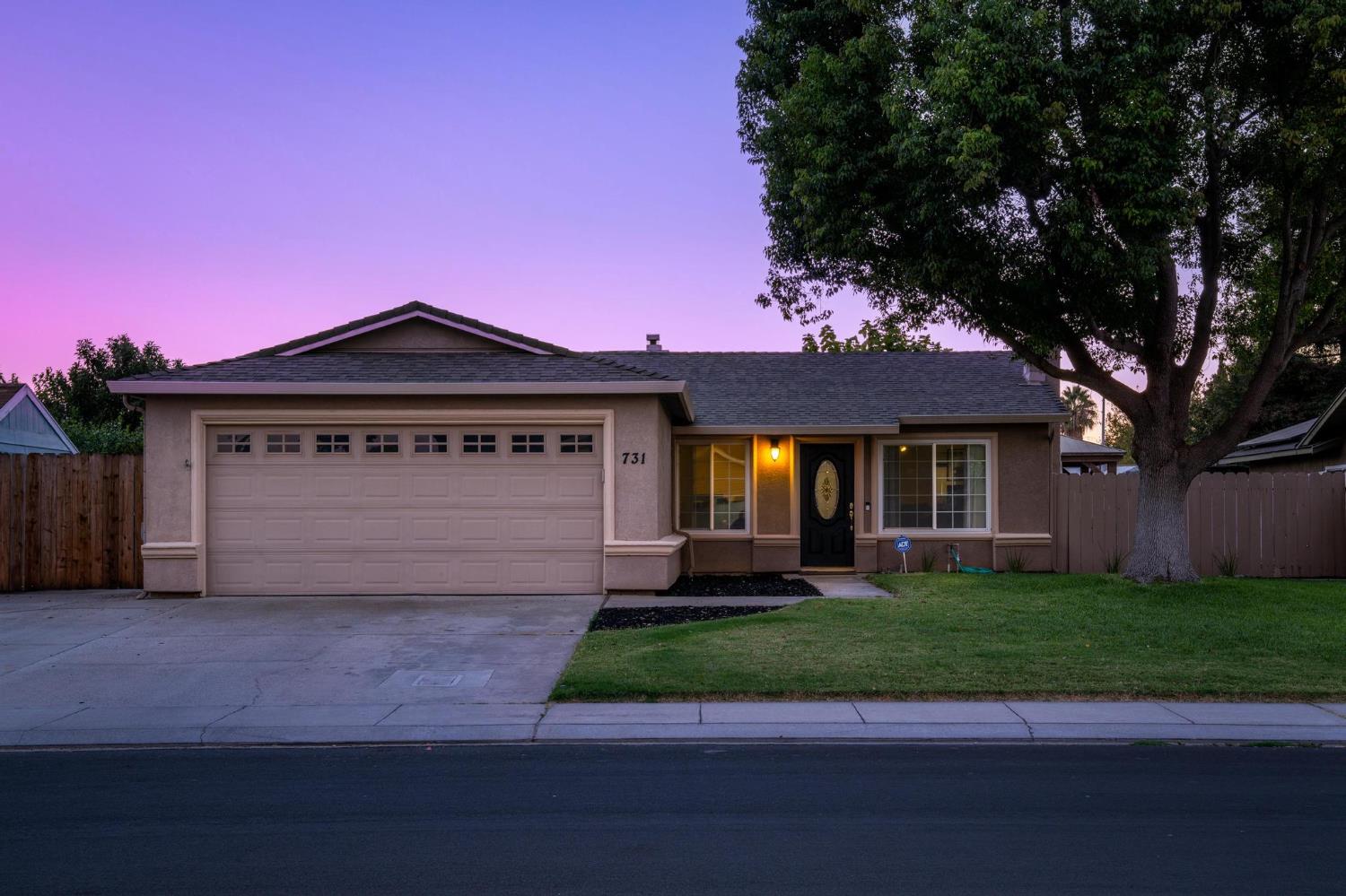 731 Dixie Lane Ripon, CA 95366 - Photo 2 of 22 a front view of a house with a yard and garage