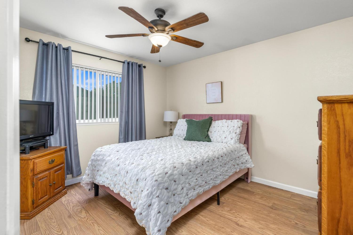 731 Dixie Lane Ripon, CA 95366 - Photo 8 of 22 a bedroom with a bed and a flat screen tv