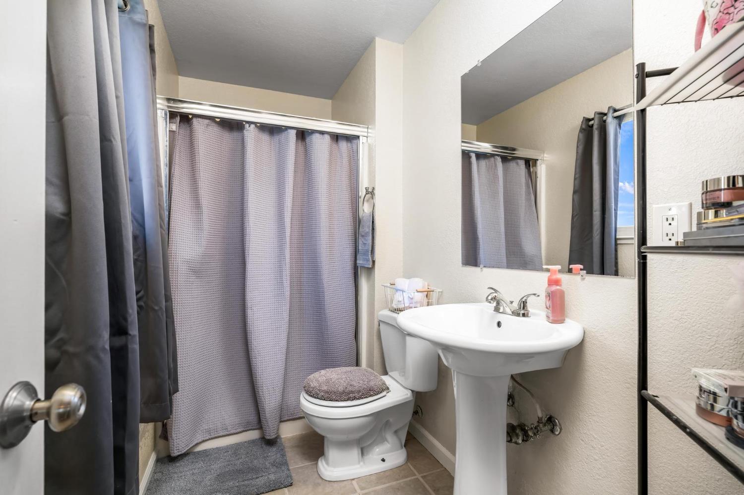 731 Dixie Lane Ripon, CA 95366 - Photo 10 of 22 a bathroom with a sink toilet and shower