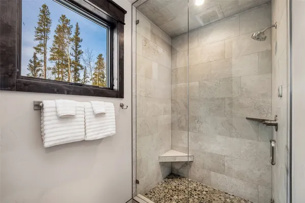 a bathroom with a shower and a sink