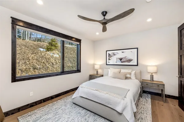 a bedroom with a large bed and a window