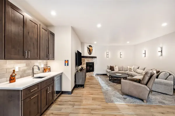 a kitchen with stainless steel appliances granite countertop a sink dishwasher stove and wooden cabinets