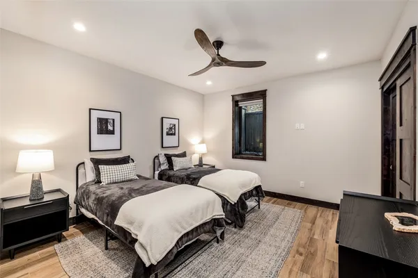 a spacious bedroom with a bed and a desk