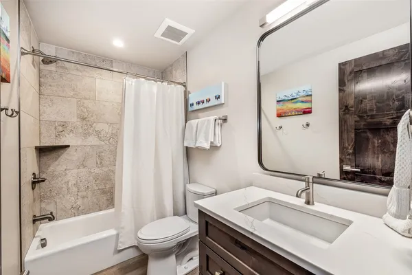 a bathroom with a sink toilet and shower
