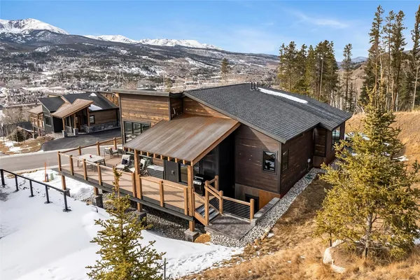 an aerial view of a house with a yard table and chairs