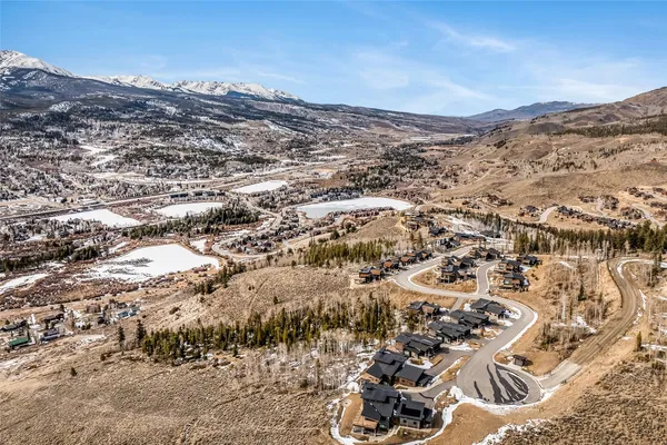 an aerial view of residential house and sandy dunes