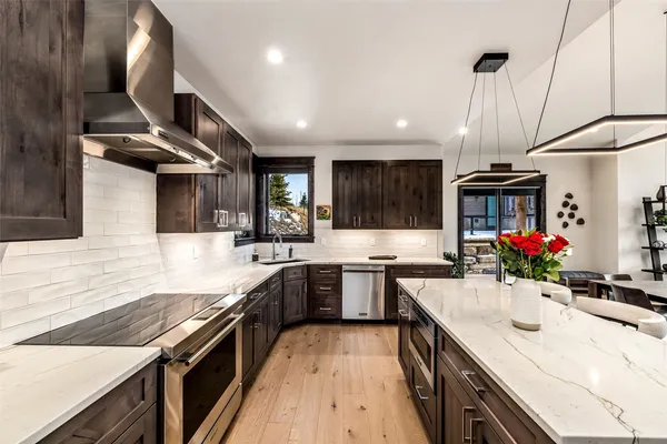 a kitchen with stainless steel appliances granite countertop sink stove and cabinets