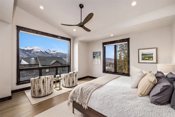 a bedroom with furniture and a large window