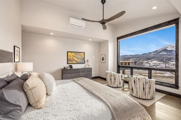 a bedroom with furniture and large windows