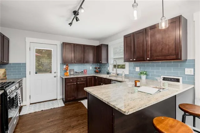 a kitchen with stainless steel appliances granite countertop wooden cabinets a sink and dishwasher