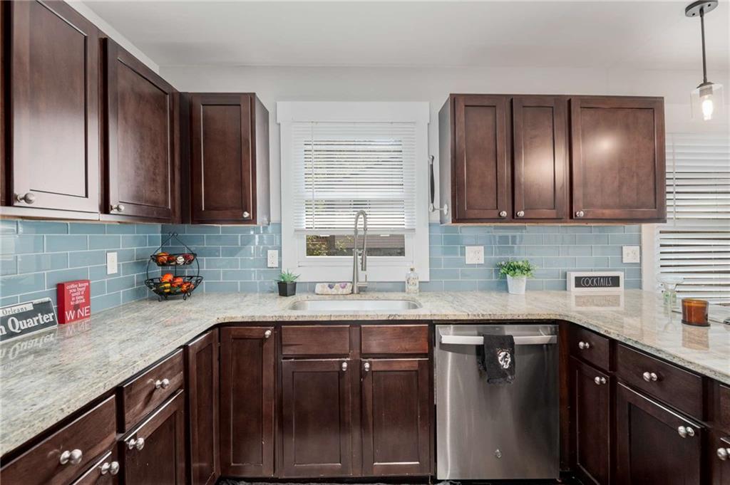 2046 Settle Circle Southeast Atlanta, GA 30316 - Photo 13 of 36 a kitchen with stainless steel appliances granite countertop wooden cabinets a sink and dishwasher