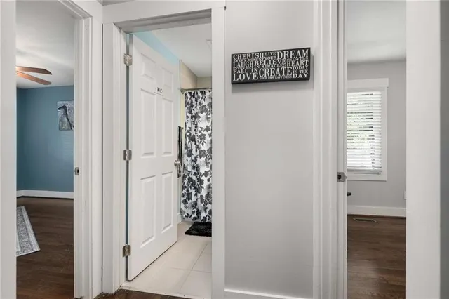 a bathroom with a granite countertop toilet sink and mirror