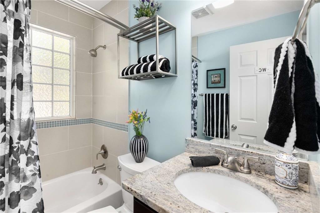 2046 Settle Circle Southeast Atlanta, GA 30316 - Photo 20 of 36 a bathroom with a granite countertop sink and a mirror