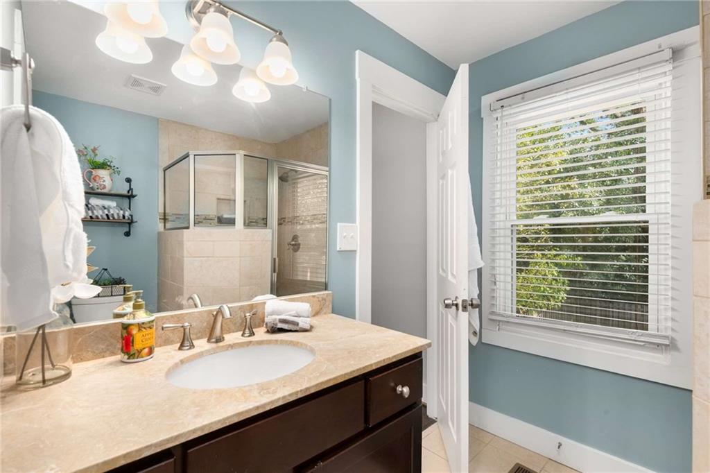 2046 Settle Circle Southeast Atlanta, GA 30316 - Photo 26 of 36 a bathroom with a sink and a mirror