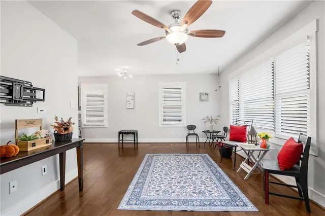 a living room with furniture and wooden floor