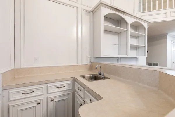 a kitchen with a sink and cabinets