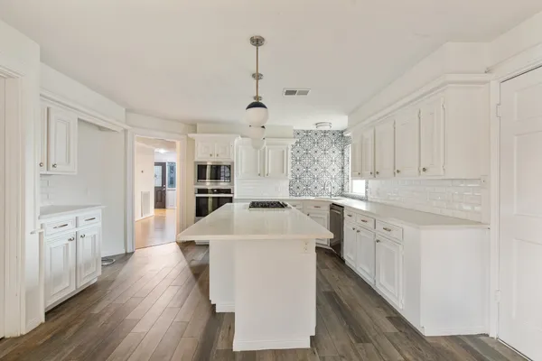 a kitchen with cabinets a sink and appliances