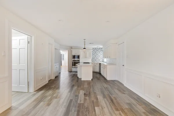 a view of a kitchen with wooden floor